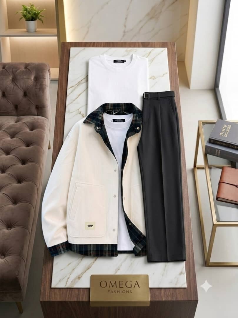 Omega Fashions combo set with cream corduroy jacket, white polo and black flare trousers on marble display.