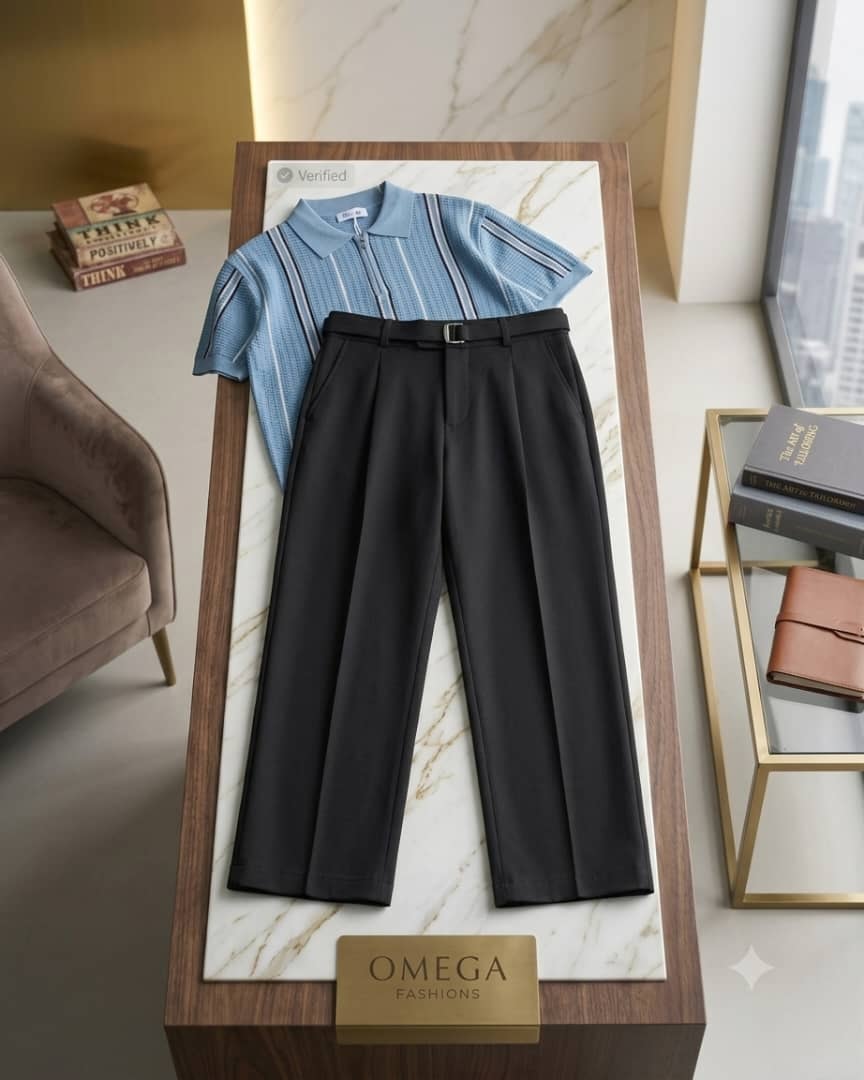 Blue striped polo shirt and black pleated pants on marble pedestal with Omega sign.