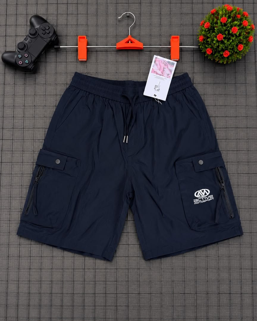 Navy cargo shorts with Active Motorsports logo on grid background.