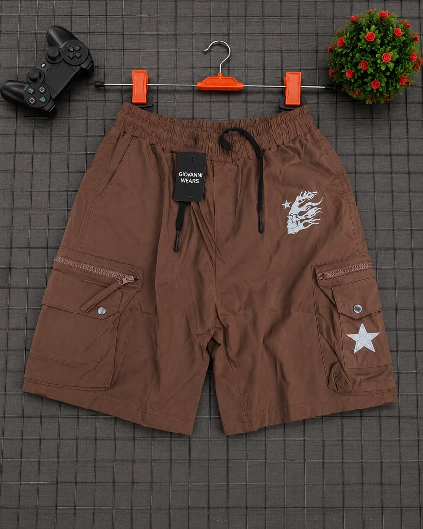 Brown cargo shorts with skull graphic and star on grid background.