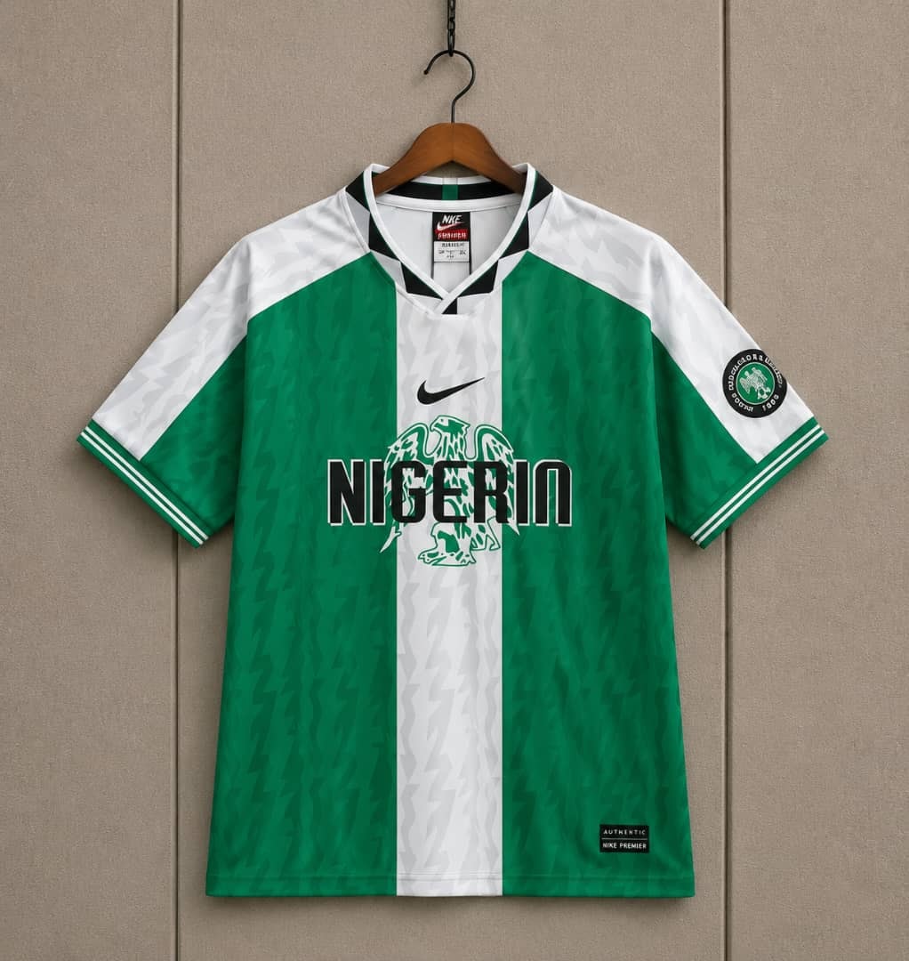 Green and white Nike Nigeria Super Eagles jersey on hanger.