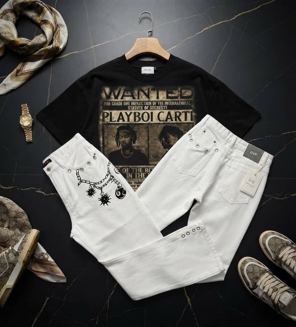 Black oversized t-shirt with Playboi Carti wanted graphic paired with white jeans with chain and spike details.