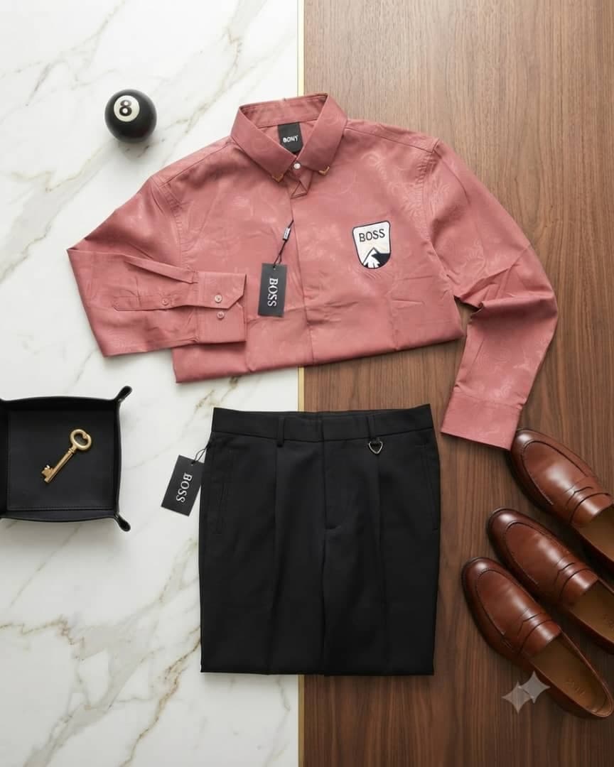Dusty pink patterned Boss logo shirt paired with black trousers on split marble and wood background.