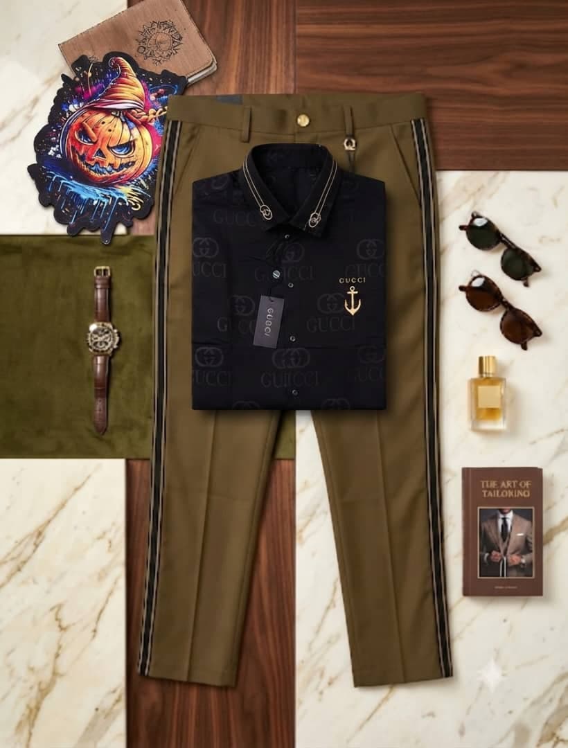 Black Gucci printed shirt with anchor detail paired with olive striped trousers on marble surface.