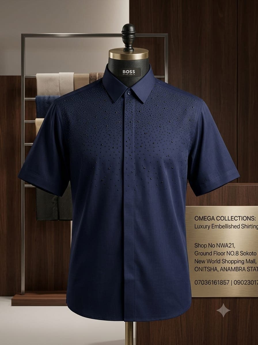 Navy short sleeve studded shirt on mannequin with black embellishments on chest.