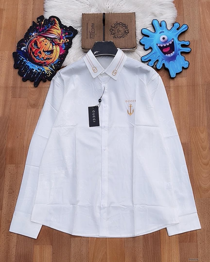 White Gucci monogram long sleeve shirt with anchor embroidery laid flat.