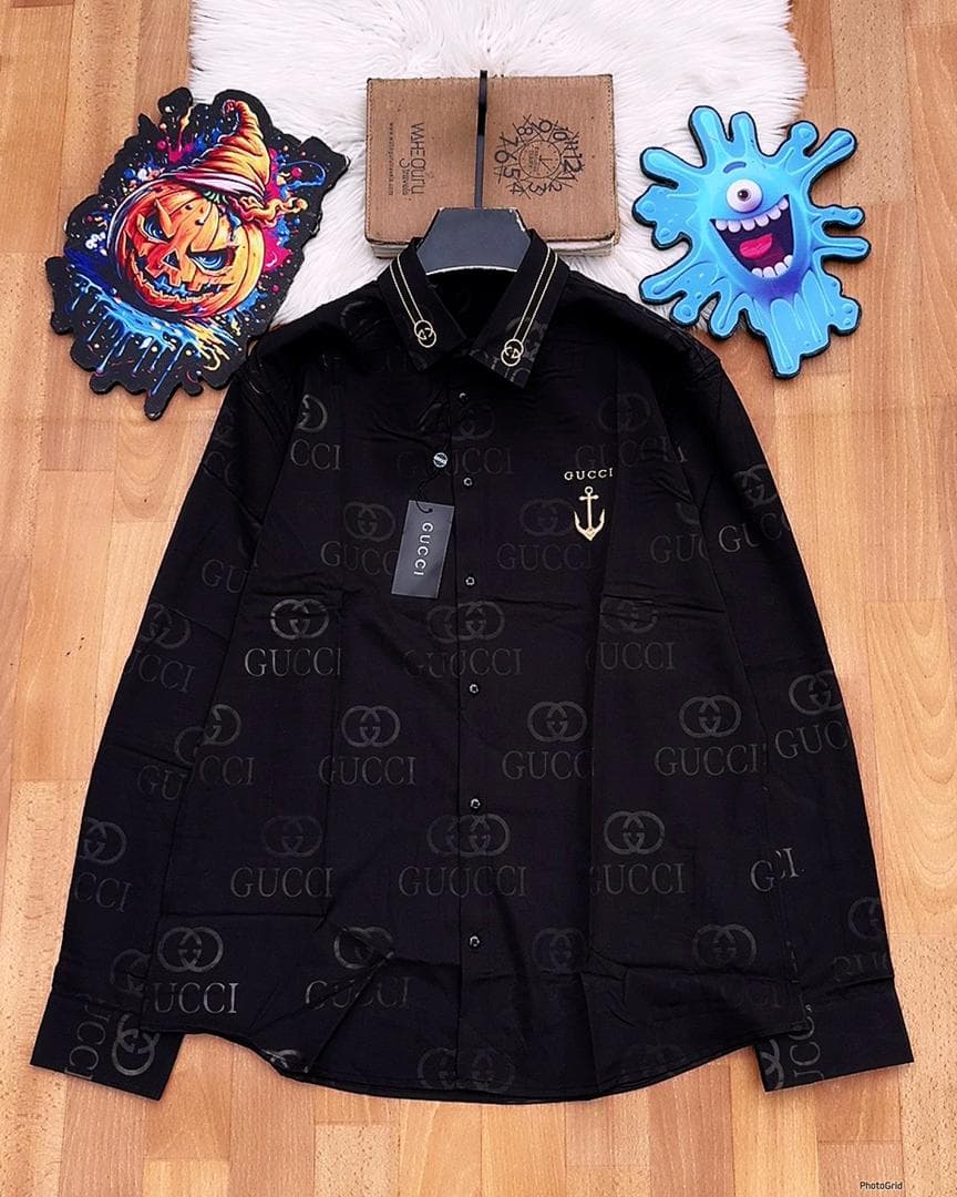 Black Gucci monogram long sleeve shirt with anchor embroidery laid flat.