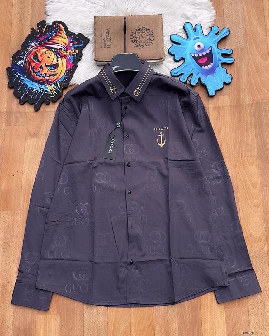Navy Gucci monogram long sleeve shirt with anchor embroidery laid flat.