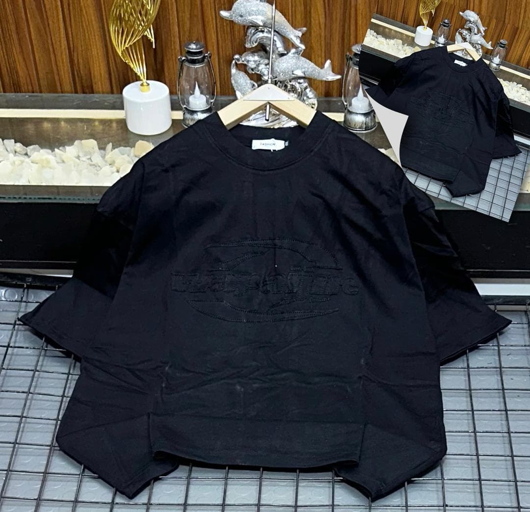 Black oversized t-shirt with embroidered Wayoflife oval logo, flat lay with inset.