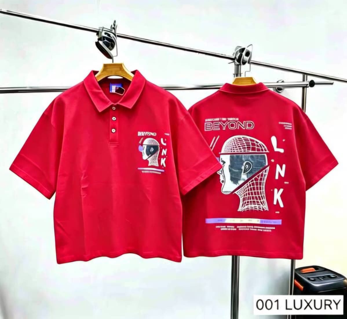Red polo shirt with helmet graphic, front and back views.