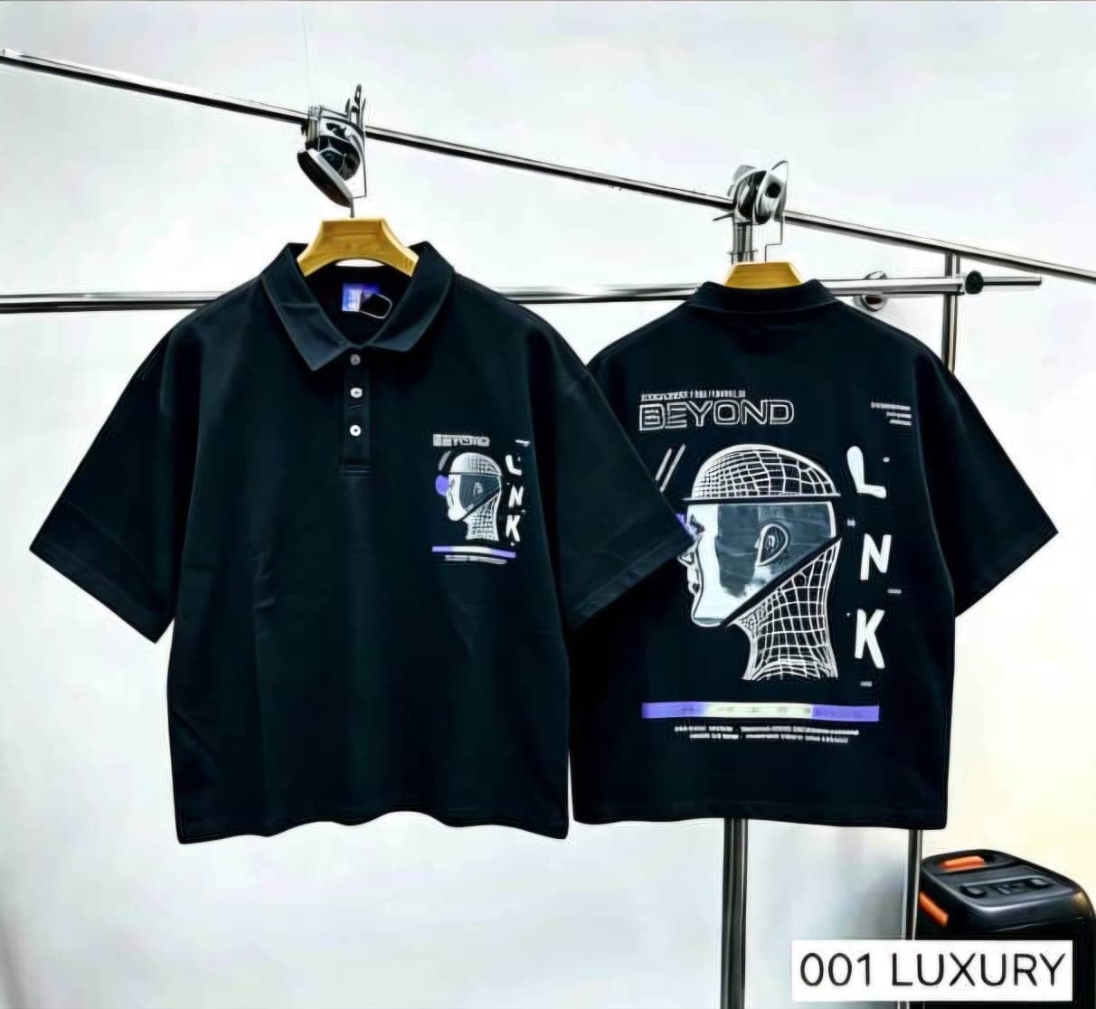 Black polo shirt with helmet graphic, front and back views.