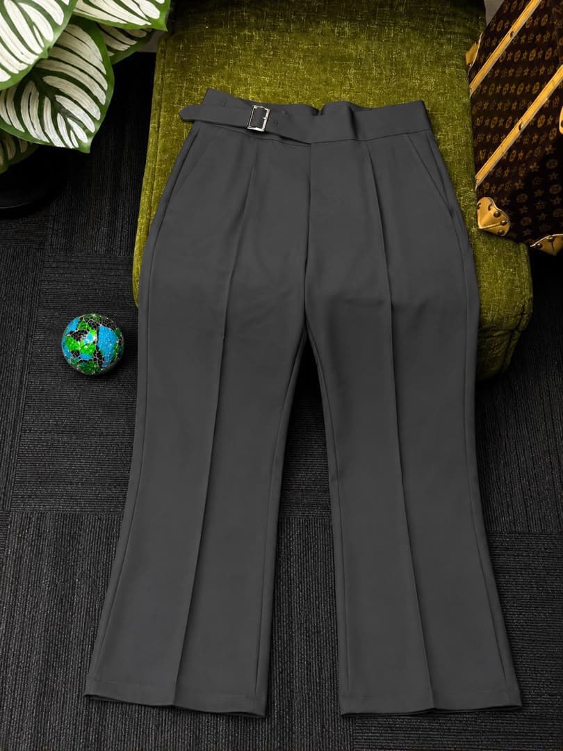 Front view of gray high-waisted flare trousers with belt.