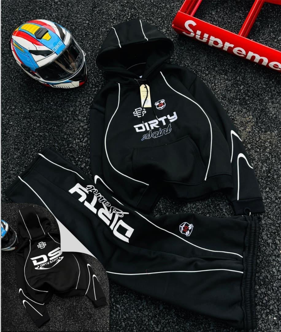 Black Dirty Saint graphic hoodie and joggers two-piece set with helmet and Supreme box.