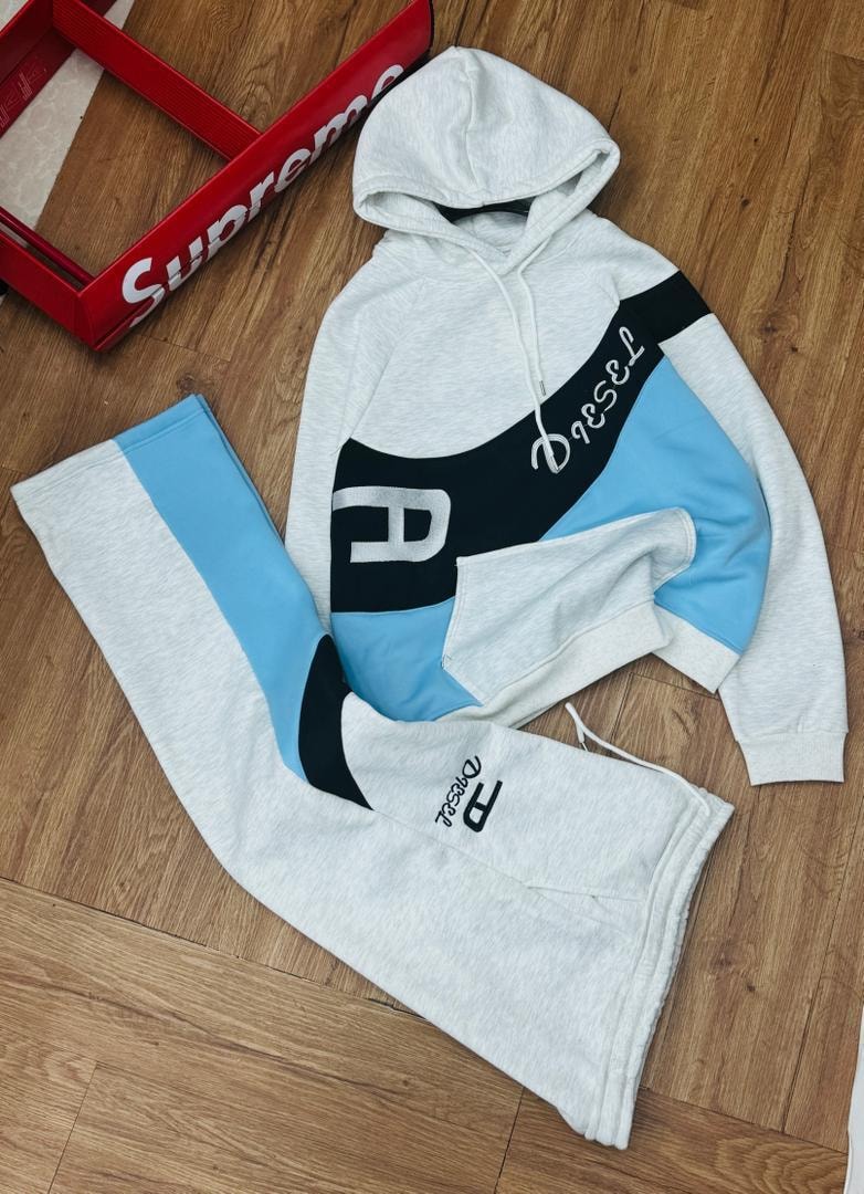 Gray Diesel colorblock hoodie and joggers two-piece set laid flat on wood.