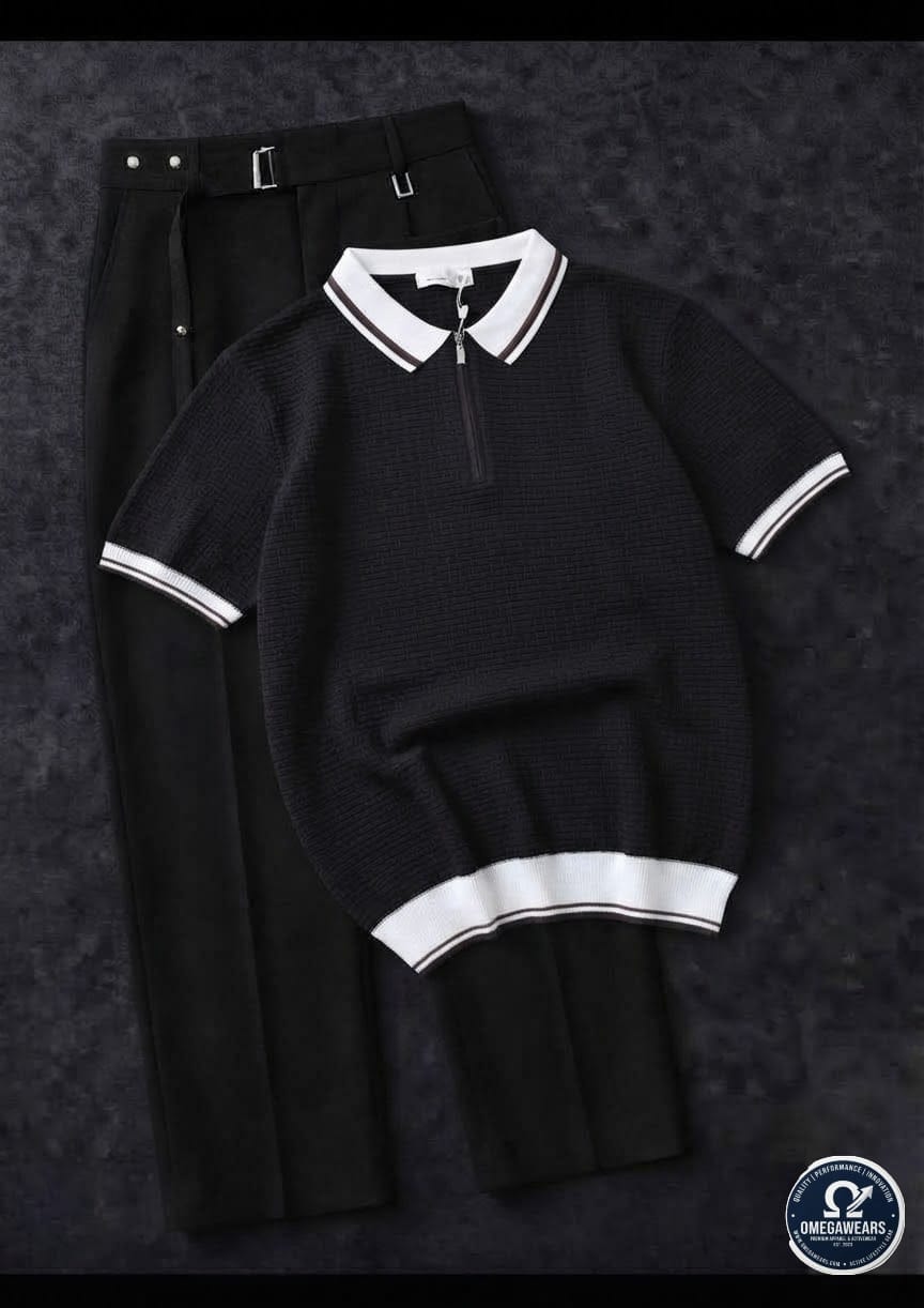 Black knitted polo with white trim paired with black trousers.