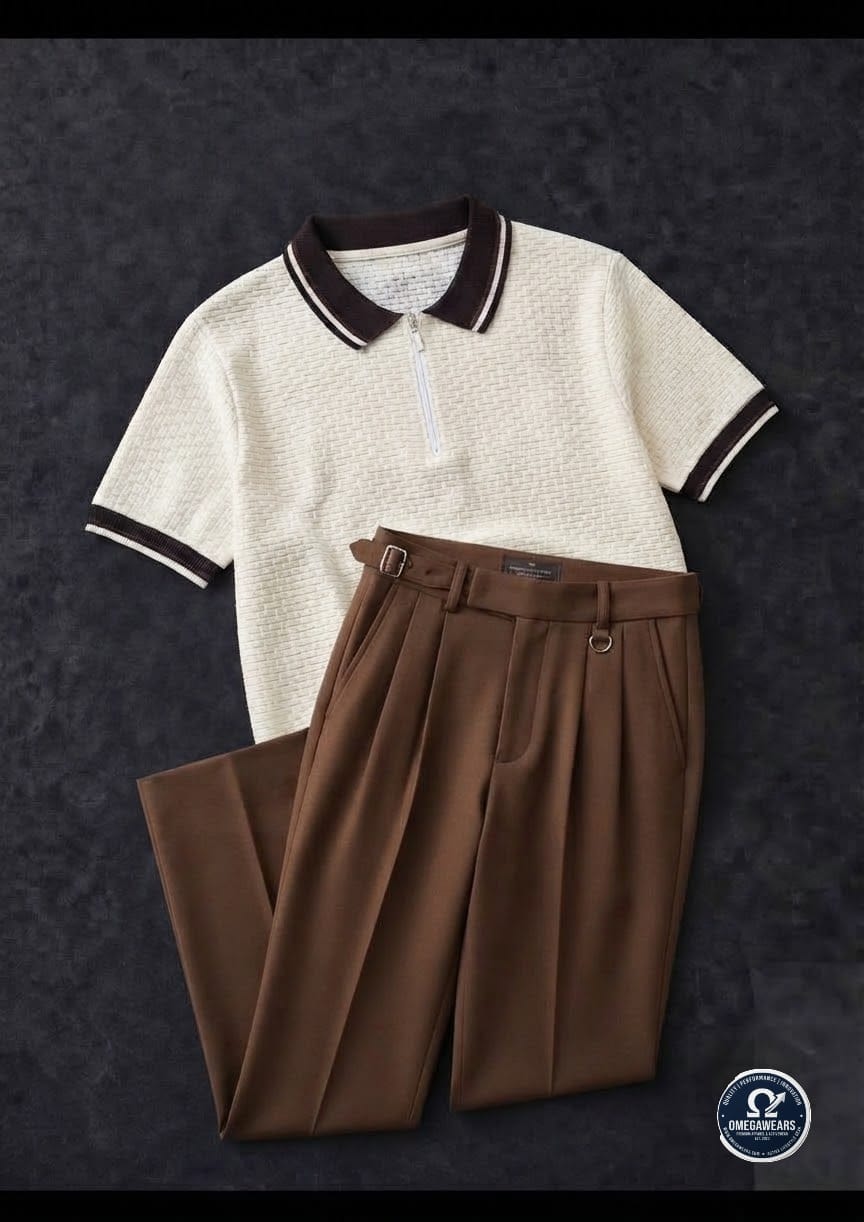 Cream knitted polo with brown trim paired with brown pleated trousers.