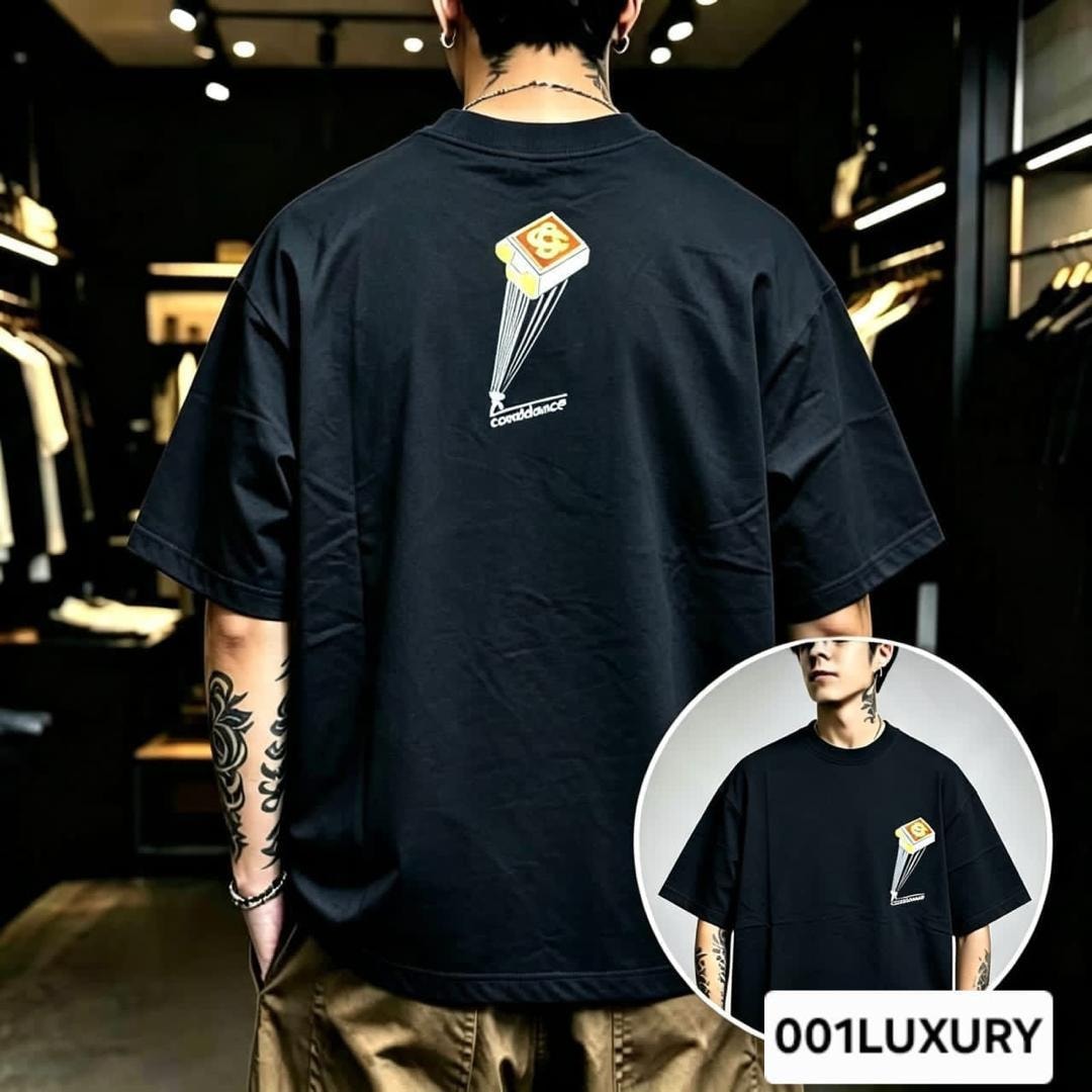 Man modeling black oversized t-shirt with confidence parachute graphic on the back.