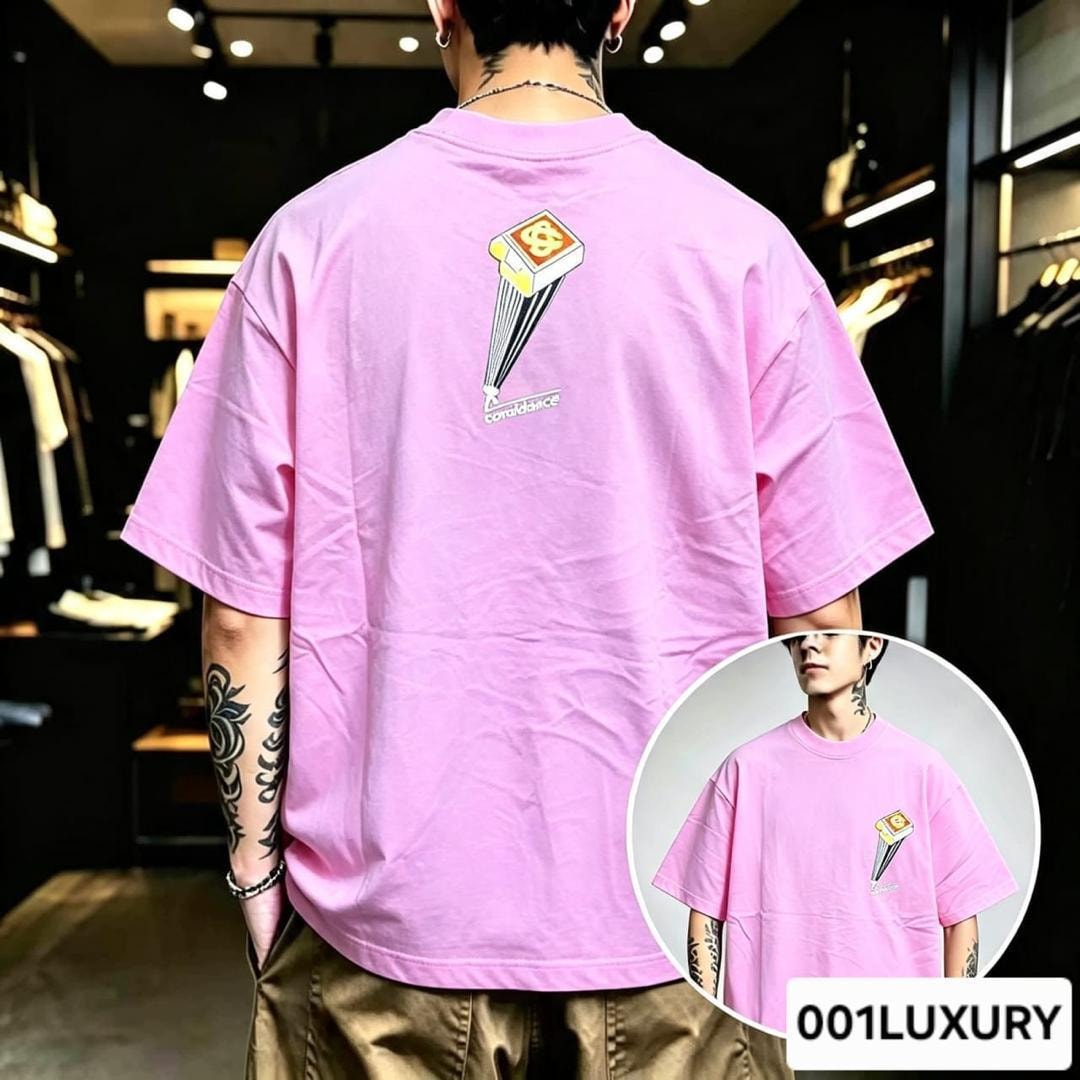 Man modeling pink oversized t-shirt with confidence parachute graphic on the back.