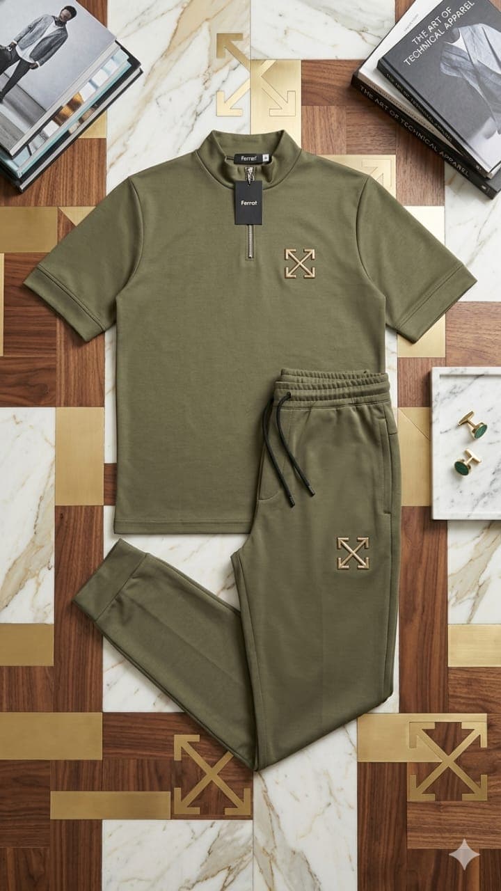 Olive green quarter-zip short sleeve top and matching jogger pants with embroidered logos in flat lay.