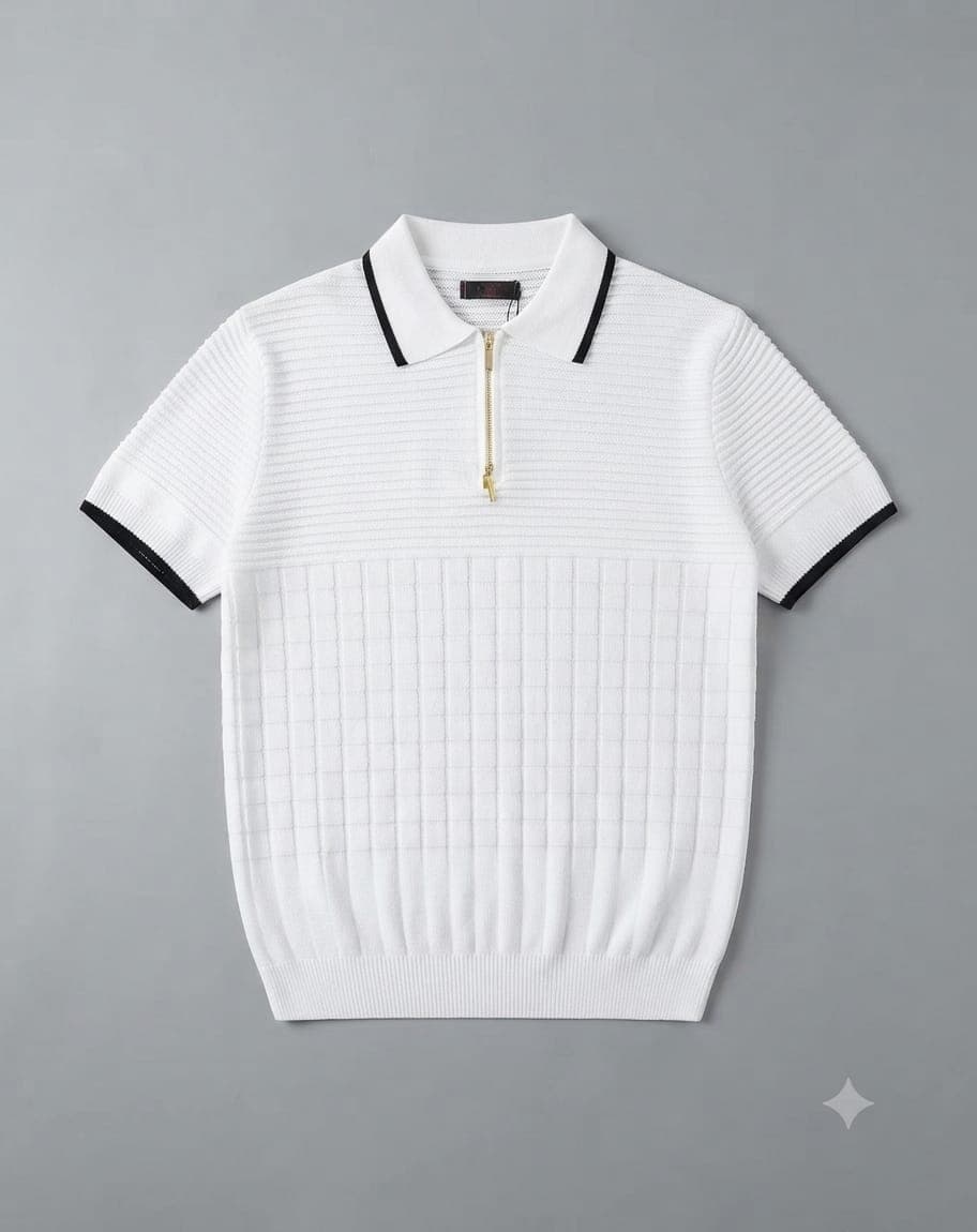 Light blue ribbed knit quarter-zip polo shirt folded on a wooden table with accessories.