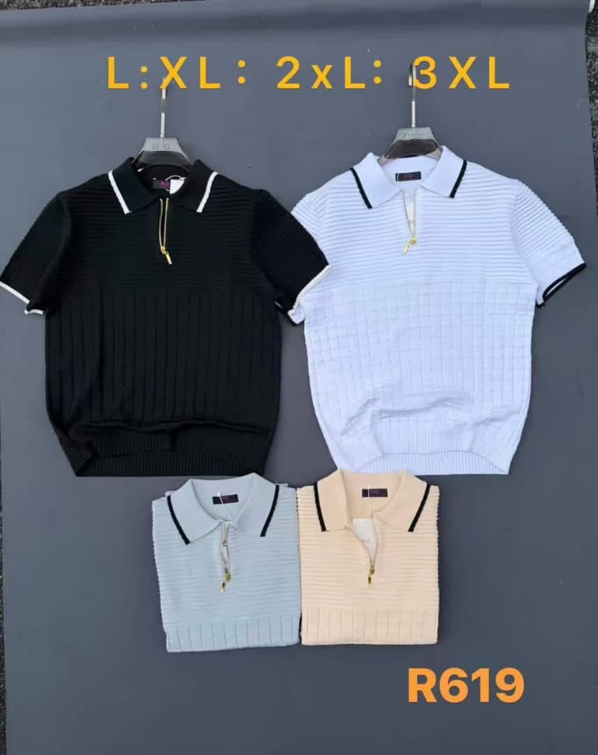 Cream ribbed knit quarter-zip polo shirt hanging on a hanger against gray background.
