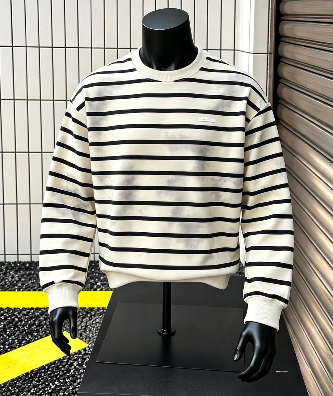 Cream and black horizontally striped sweatshirt with subtle tonal variation on mannequin.