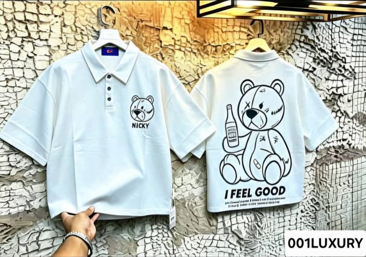 Teal polo shirt with Nicky teddy print on front and large teddy bear Feel Good graphic on back.