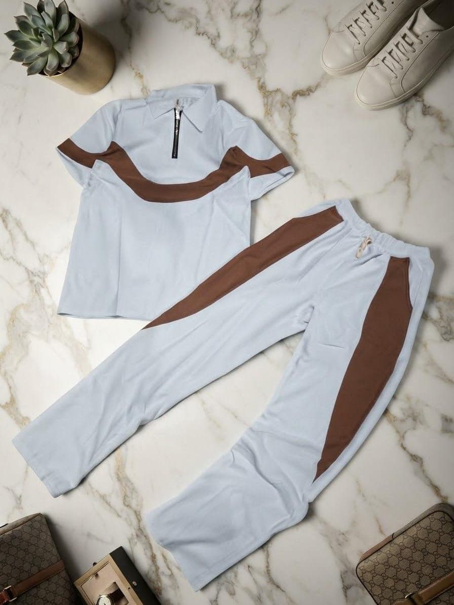 Light blue polo and pants set with brown wavy contrast stripes.