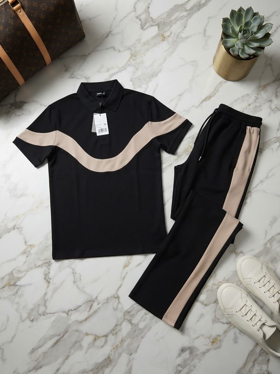 Black polo shirt with beige wavy stripe detail and matching black pants with beige side stripe.