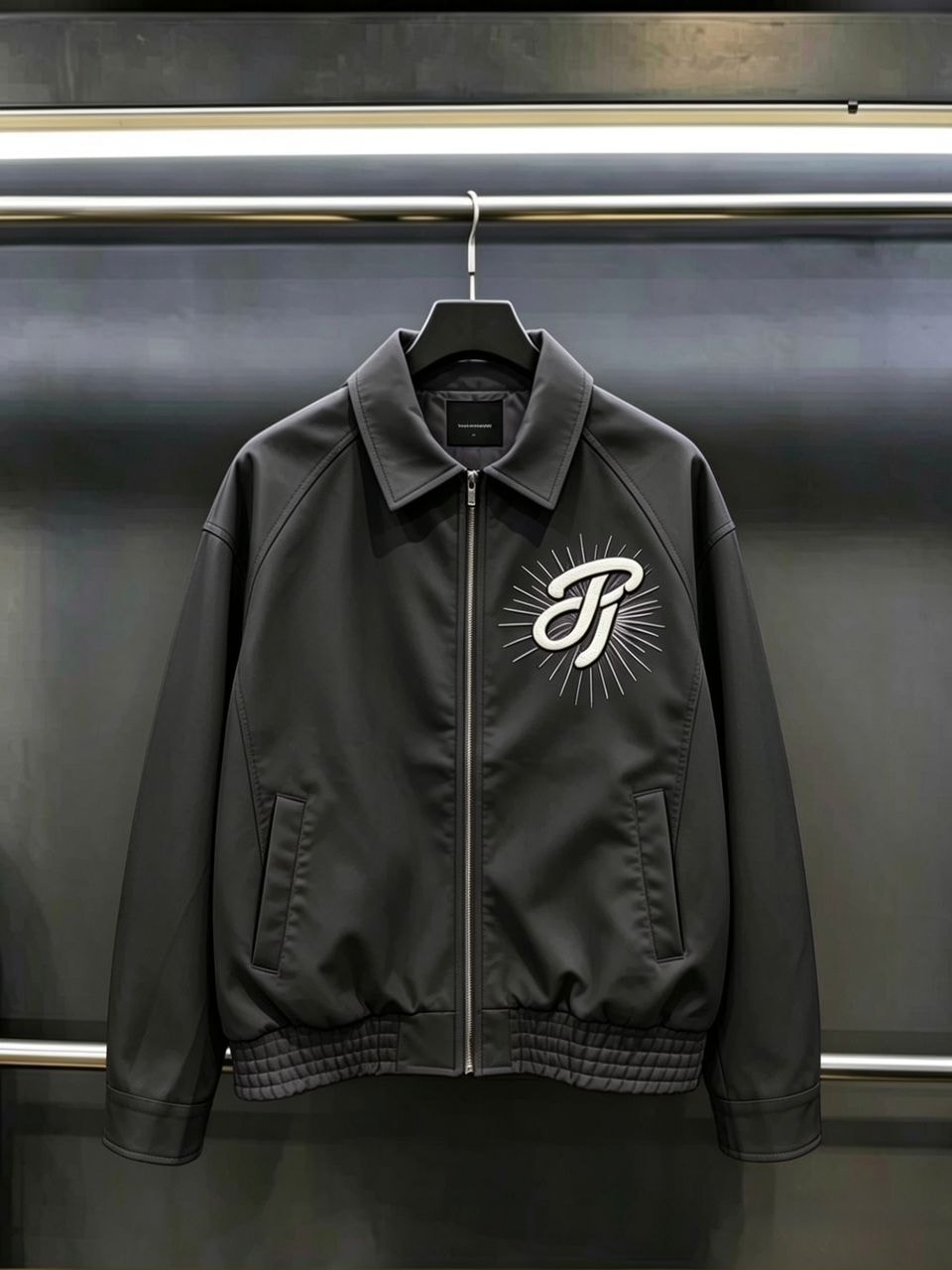 Front view of black JungleTiger leather bomber jacket showing chest logo and zip closure.