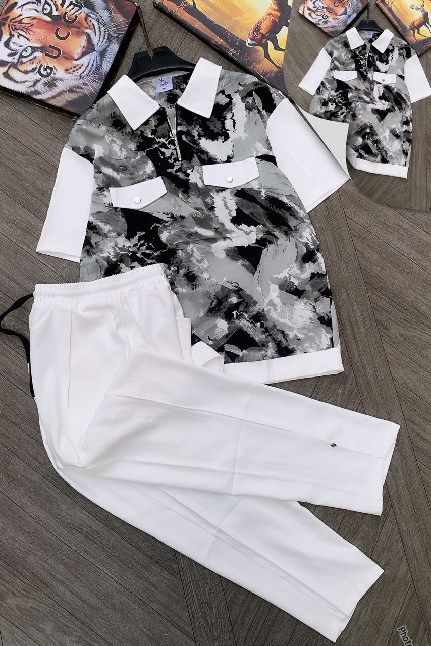 Abstract marble print two-piece set with white contrast collar and white trousers.