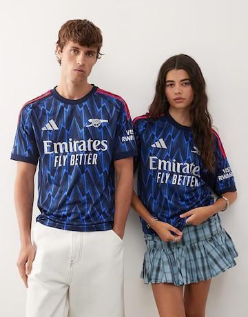 Male and female models wearing blue Adidas Arsenal zigzag pattern jerseys.