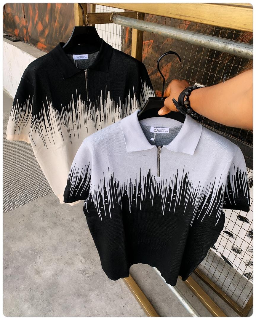 Black-white drip pattern polo shirt in foreground with black-cream version behind.