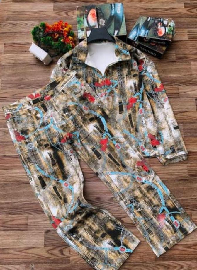Map print long sleeve shirt and trousers two-piece set on wooden floor.