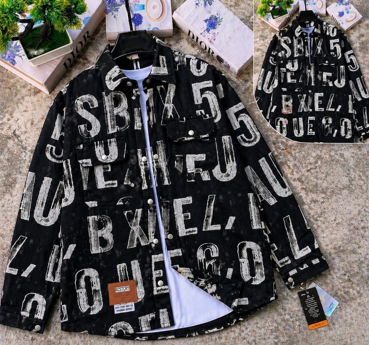 Black denim jacket with large white distressed text, layered over white tee with back view shown.