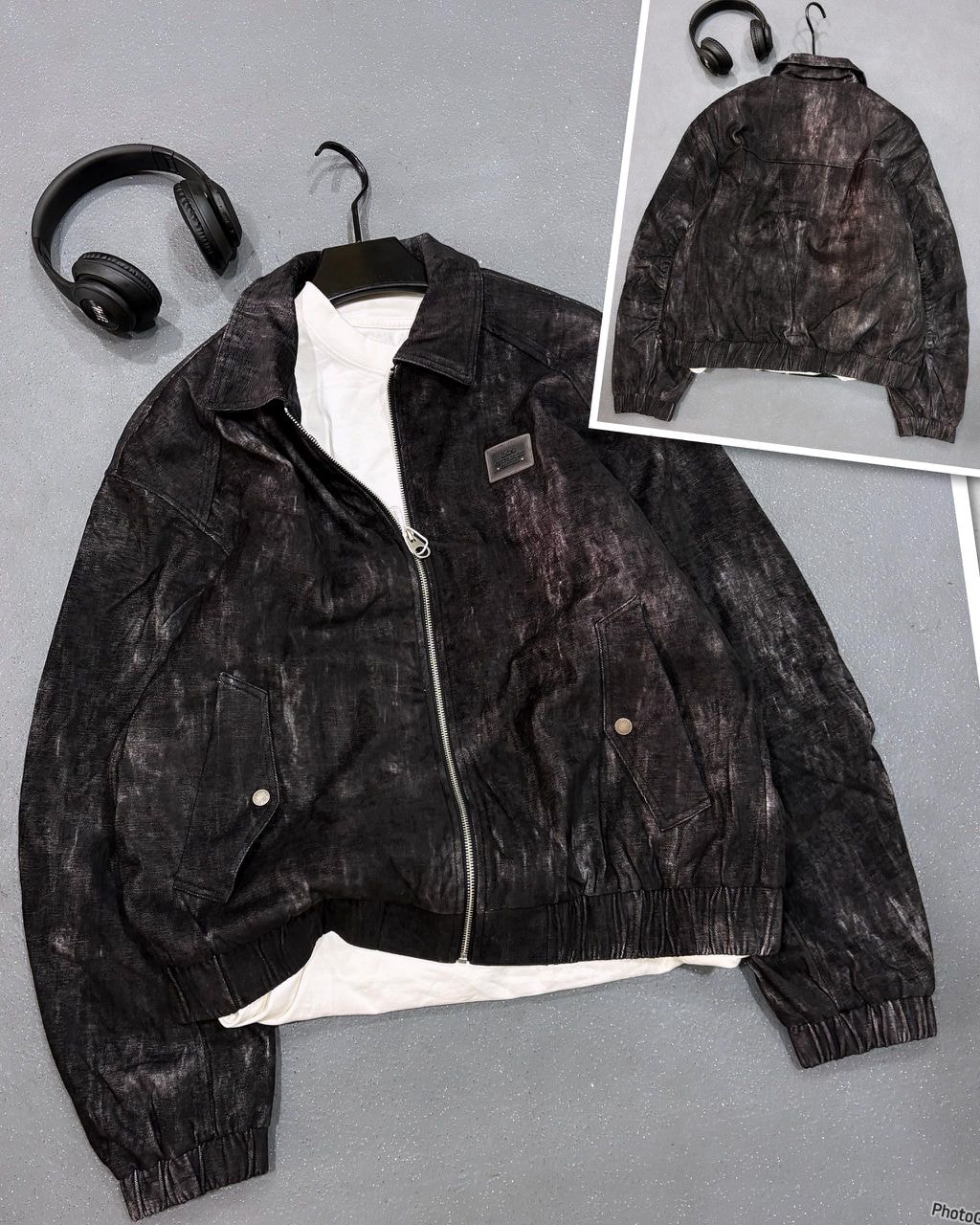 Close-up of black Omega zip-up distressed jacket with front detail and inset back view.