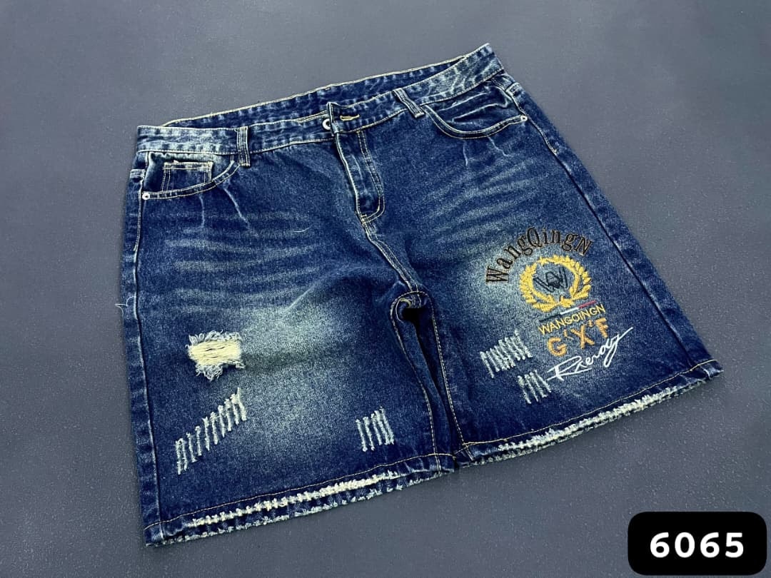 Blue denim shorts with WangQingN gold embroidery, multiple rips and faded wash.