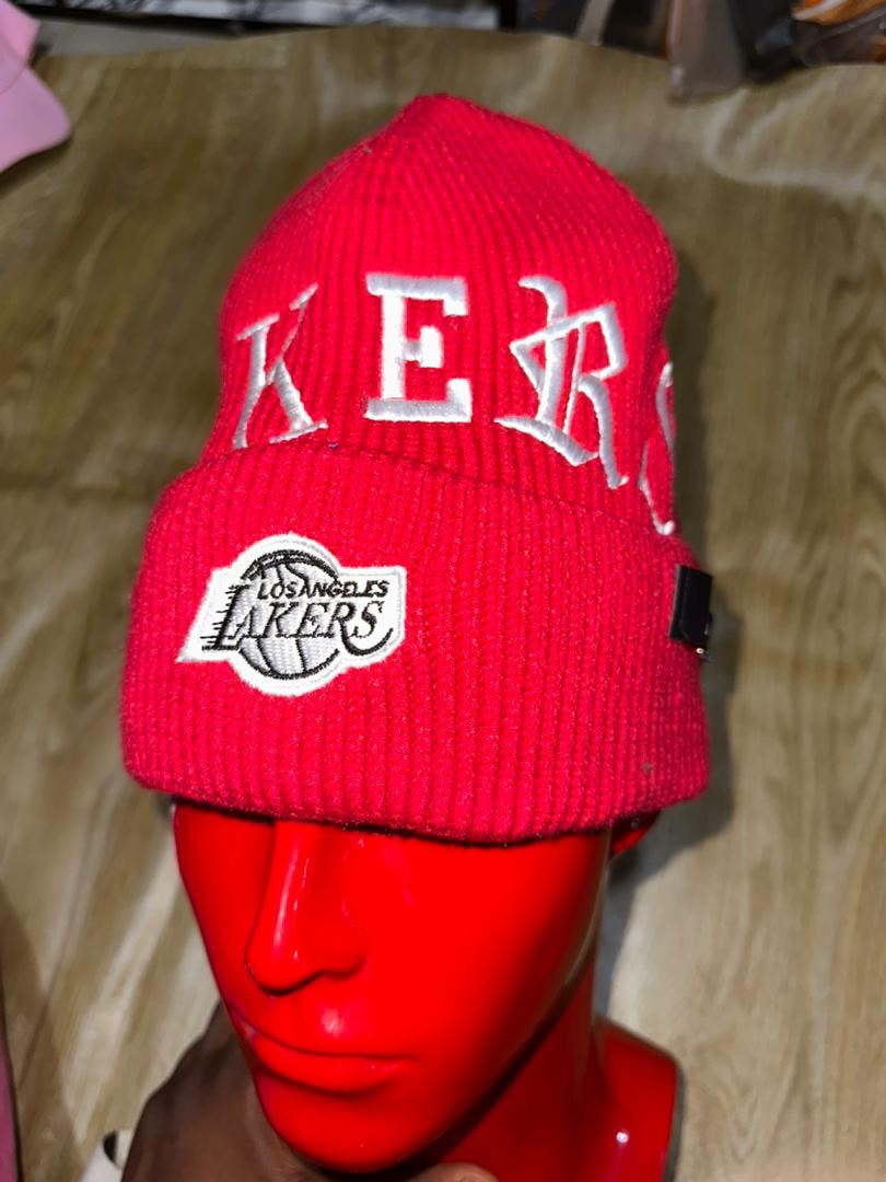 Red Lakers beanie with white text and logo displayed on mannequin head.