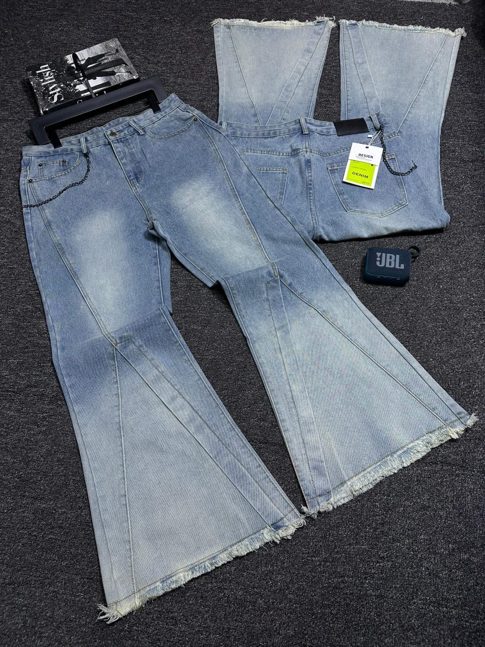 Baggy flared jeans in light blue wash with frayed hem, front and back views.
