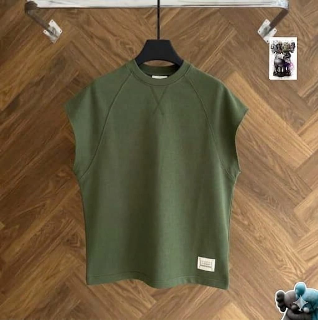 Olive raglan armless top on black hanger against wood floor.