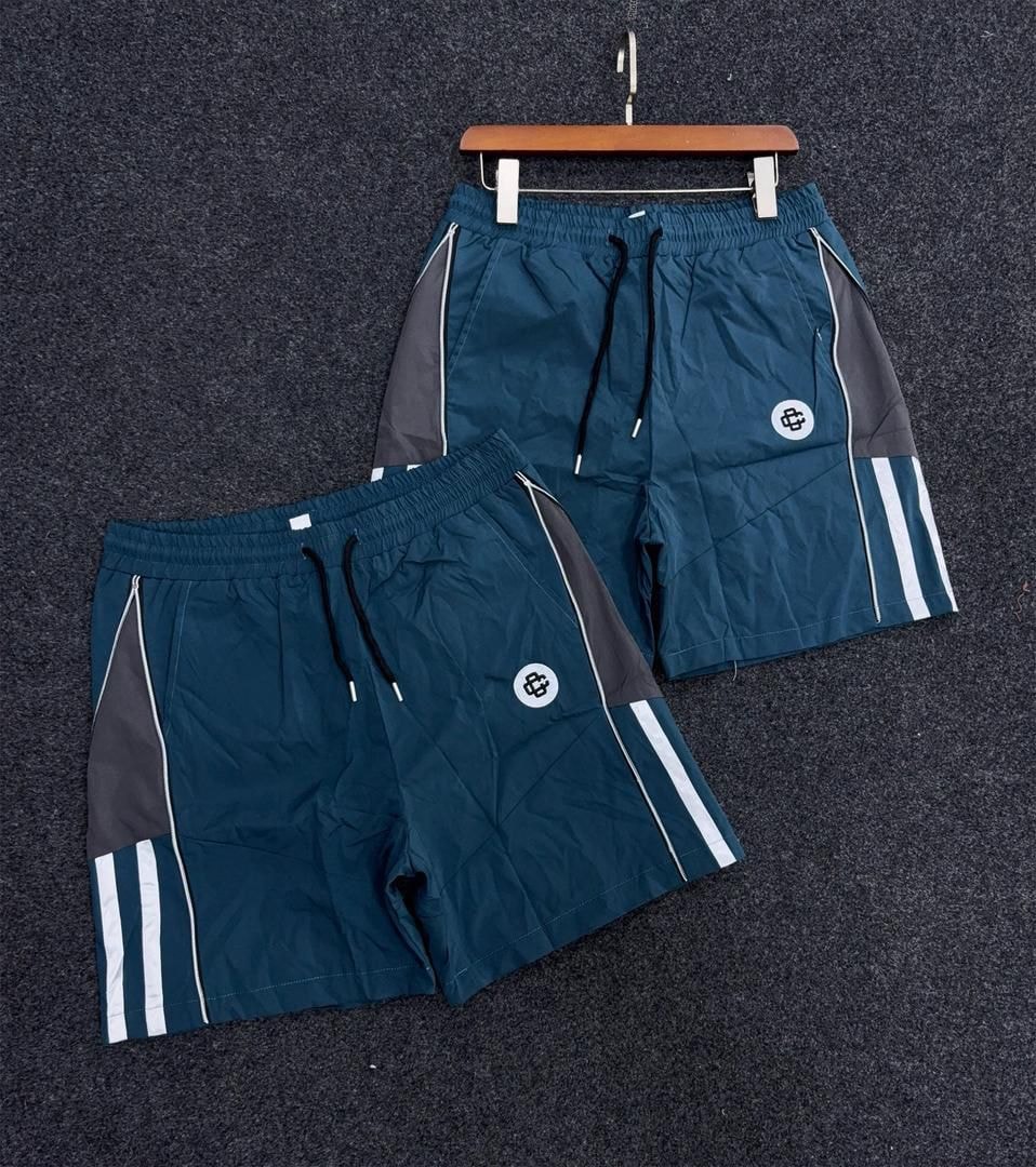 Teal monogram panel stripe shorts with white side stripes.
