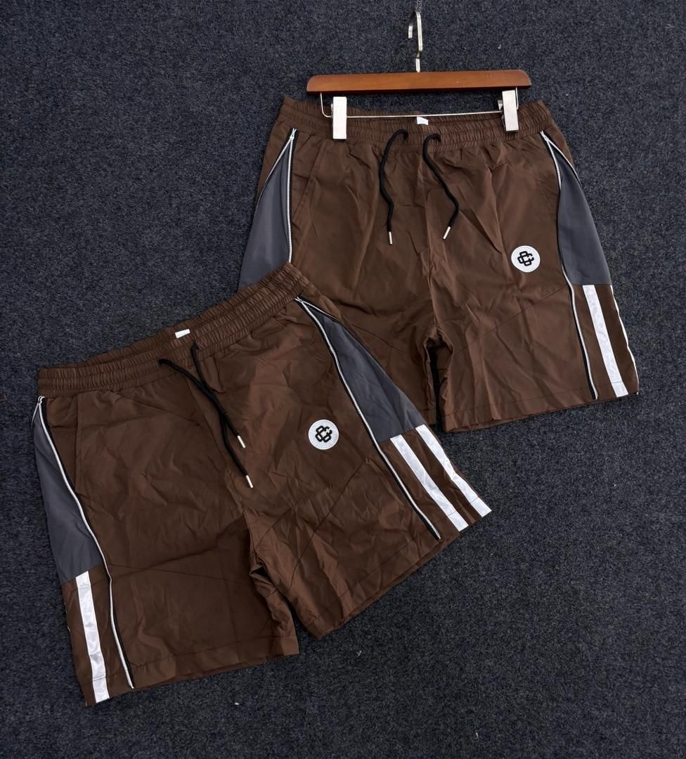 Brown monogram panel stripe shorts with white side stripes.