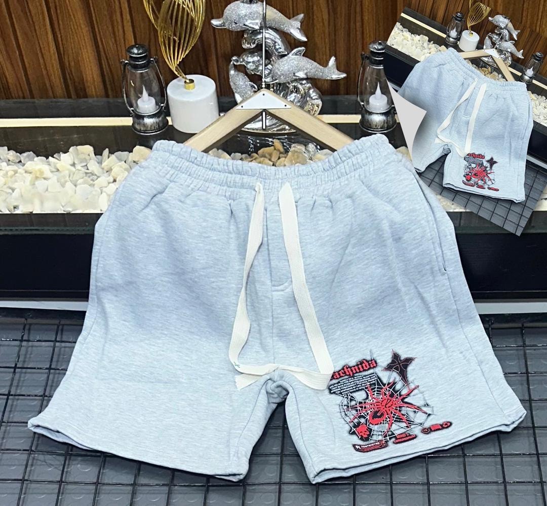 Light gray short joggers with red arachnida spider and web embroidery on the leg.