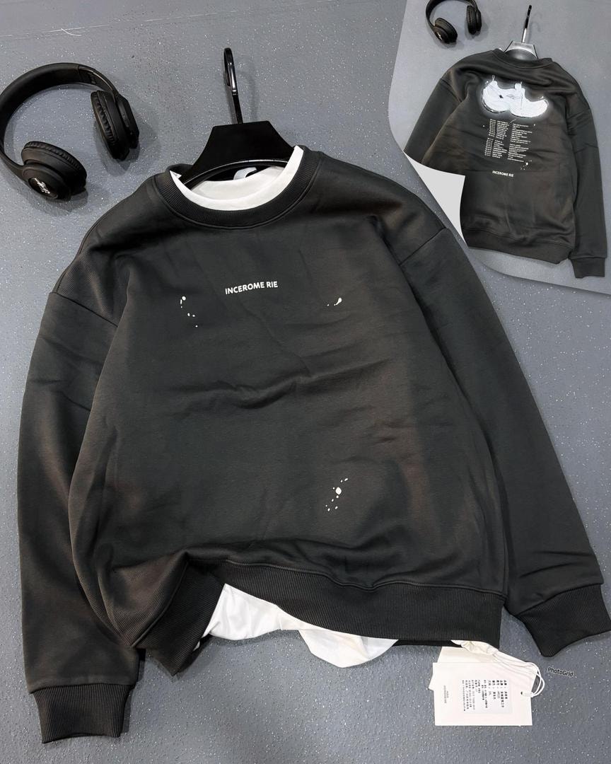 Black crewneck sweatshirt with Incerome Rie ink splash details.