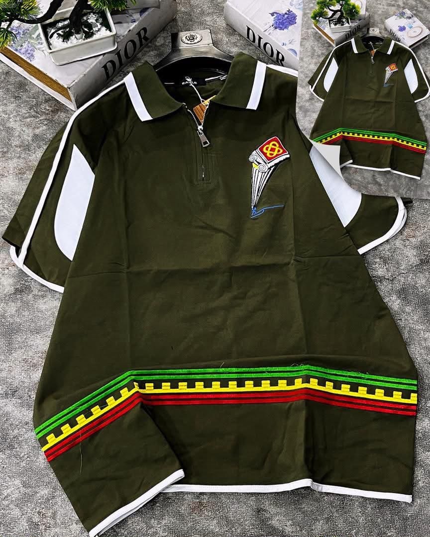 Olive green striped polo with white contrast panels, colorful hem stripes, and chest embroidery.
