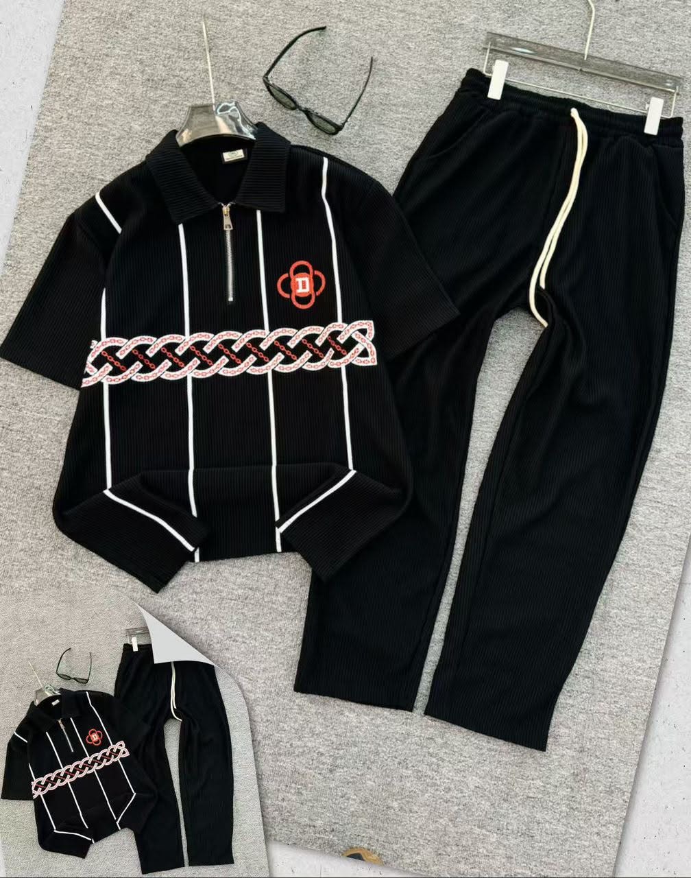 Black ribbed polo and jogger two-piece set with chain embroidery.
