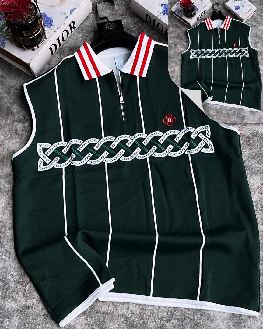 Green armless top with white chain embroidery, striped collar and zip placket.