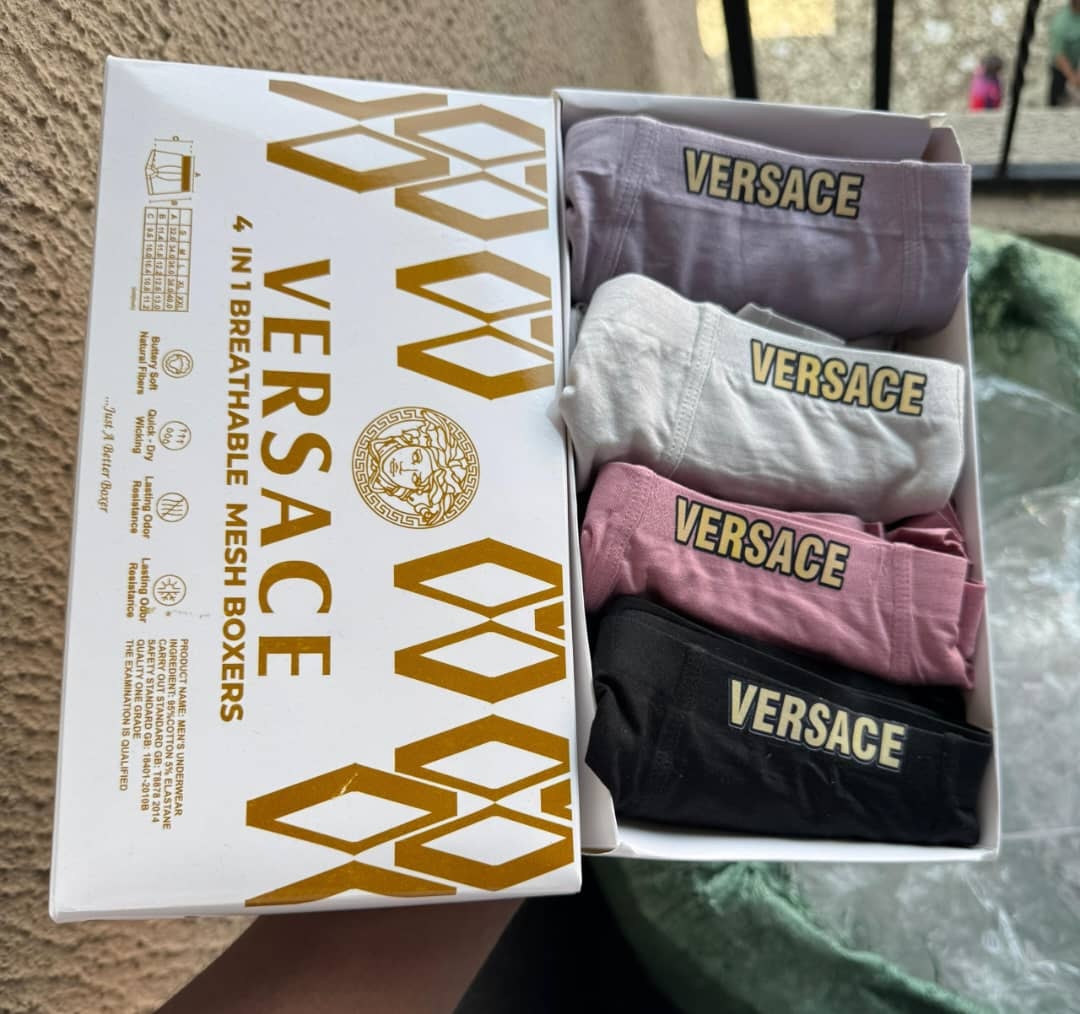 Versace 4-in-1 pack of men's boxer briefs showing lavender, white, pink, and black pairs in branded box
