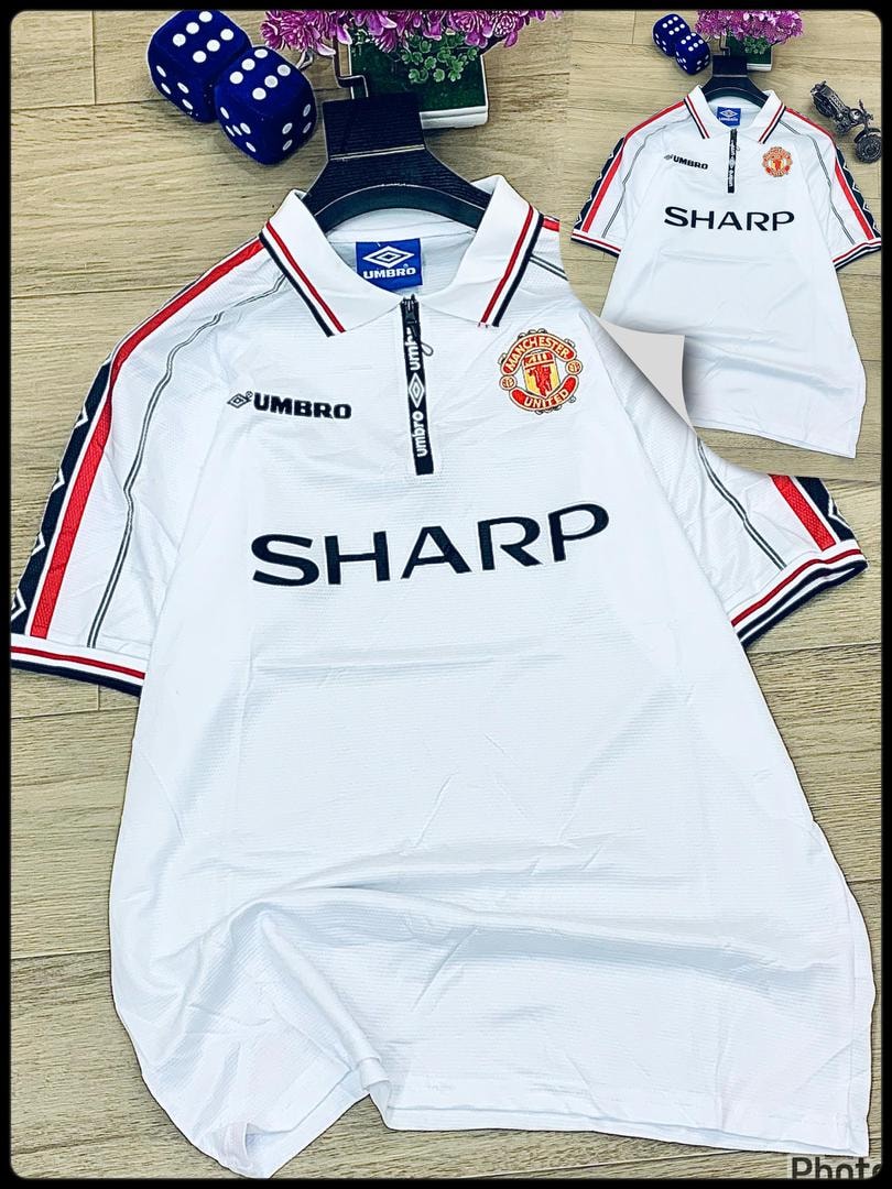 White Umbro Manchester United retro jersey with Sharp sponsor laid flat.