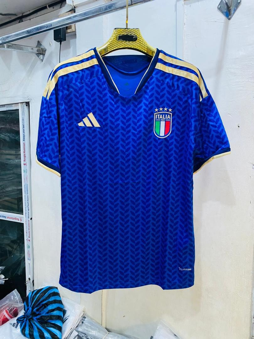 Blue patterned Italy national team soccer jersey hanging in shop.